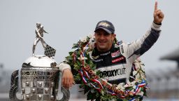 Indianapolis 500 Champion Tony Kanaan of Brazil poses with the Borg Warner Trophy at the Indianapolis Motor Speedway's "yard of bricks" on Monday, May 27.