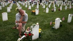 Alex Burgess gets emotional at Arlington National Cemetery in Virginia on Monday, May 27, as he visits the grave of a friend who was killed in Iraq. People across the country paid tribute to fallen military service members throughout the Memorial Day weekend.