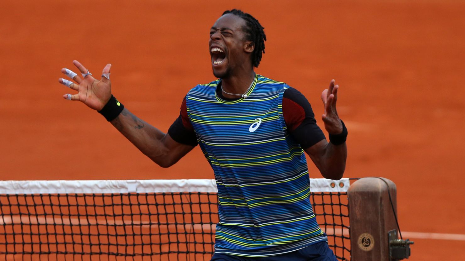 Wild card Gael Monfils celebrates his unexpected victory over fifth seed Tomas Berdych of Czech Republic.