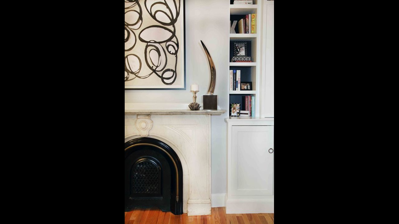 Pair vintage home features like a marble fireplace with modern art for a sharp contrast and marriage of eras.