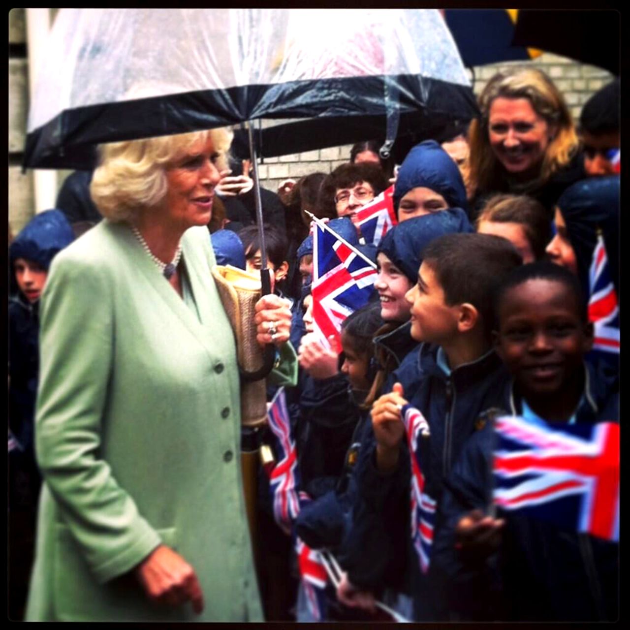 Camilla speaks with children greeting her outside the headquarters of la Garde Républicaine -- the Republican Guard.