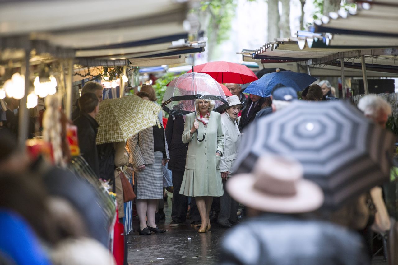 Camilla strolls through the Parisian market. At another stall, she bought five dresses for her grand-daughters from a trader who described the duchess as polite and said she "loved everything." 