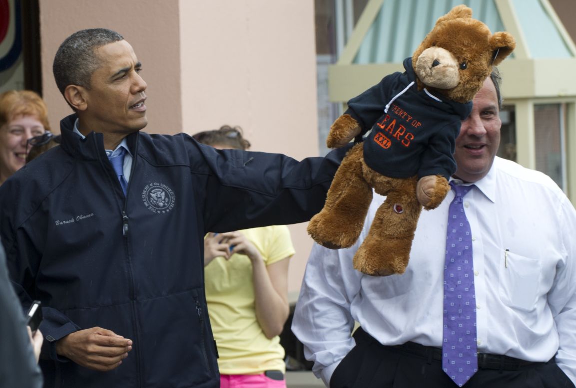 Obama holds up a stuffed bear after playing an arcade game along the Point Pleasant boardwalk.