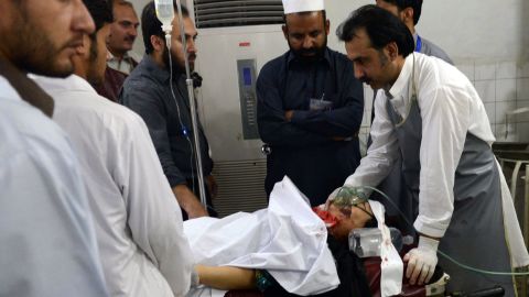 Paramedics treat an injured polio health worker at a hospital following an attack by gunmen in Peshawar on Tuesday,