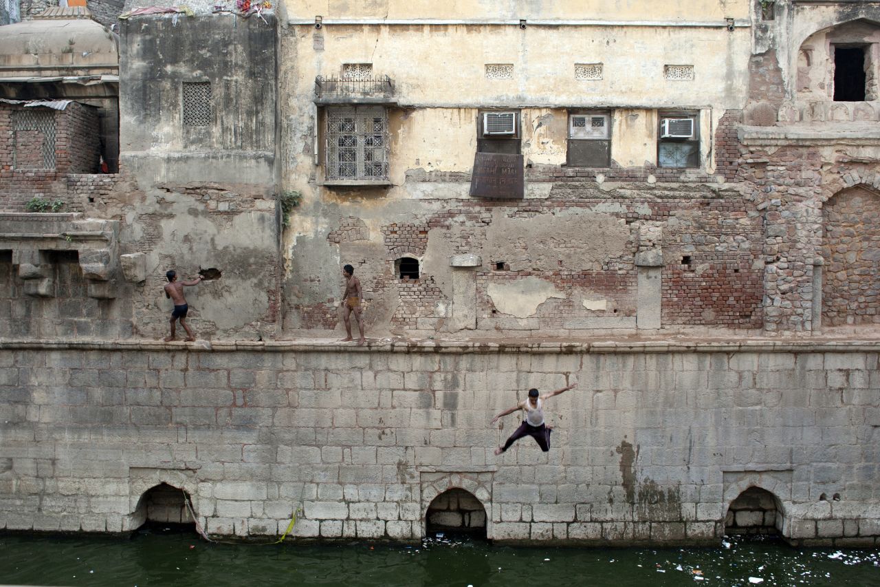 Indian youth jump from a wall into the Nizamuddin Baoli on a hot day in New Delhi, India, on May 28. 