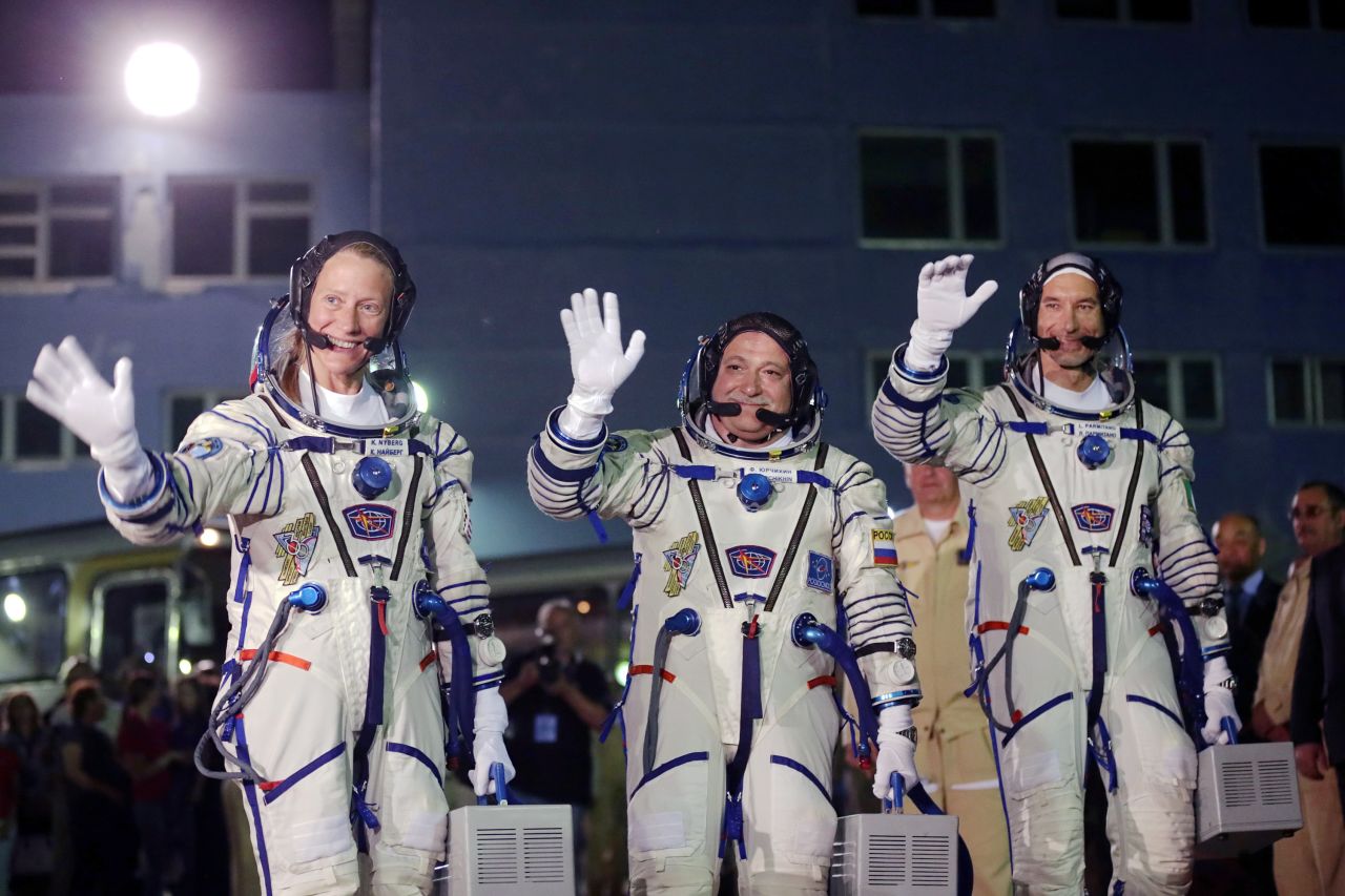 The astronauts wave to a crowd outside their hotel on May 28.