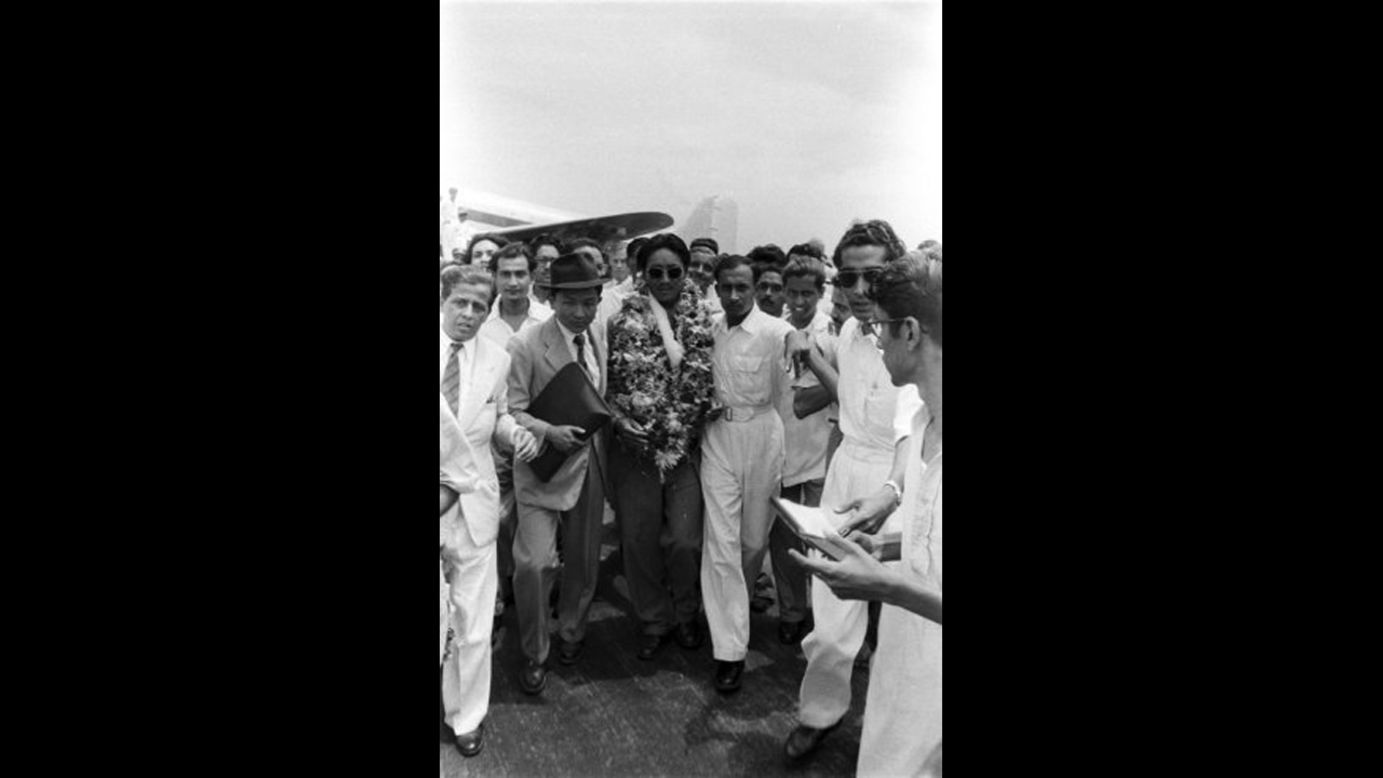 Tenzing arrives in India after his ascent.