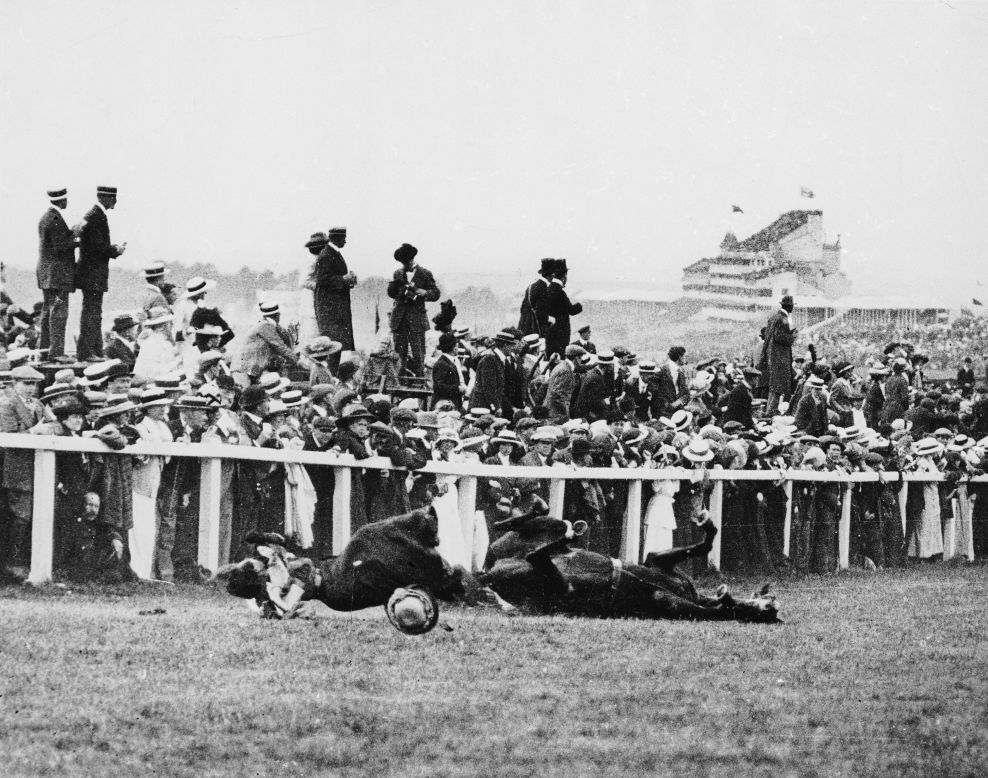 In a shocking instant, Suffragette Emily Davison is knocked to the ground by the King's horse during the 1913 Epsom Derby. Yet take a closer look and you'll see the majority of spectators are instead watching the race.