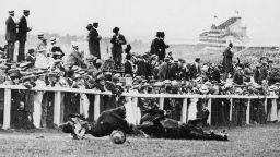 In a shocking instant, Suffragette Emily Davison is knocked to the ground by the King's horse during the 1913 Epsom Derby. Yet take a closer look and you'll see the majority of spectators are instead watching the race.