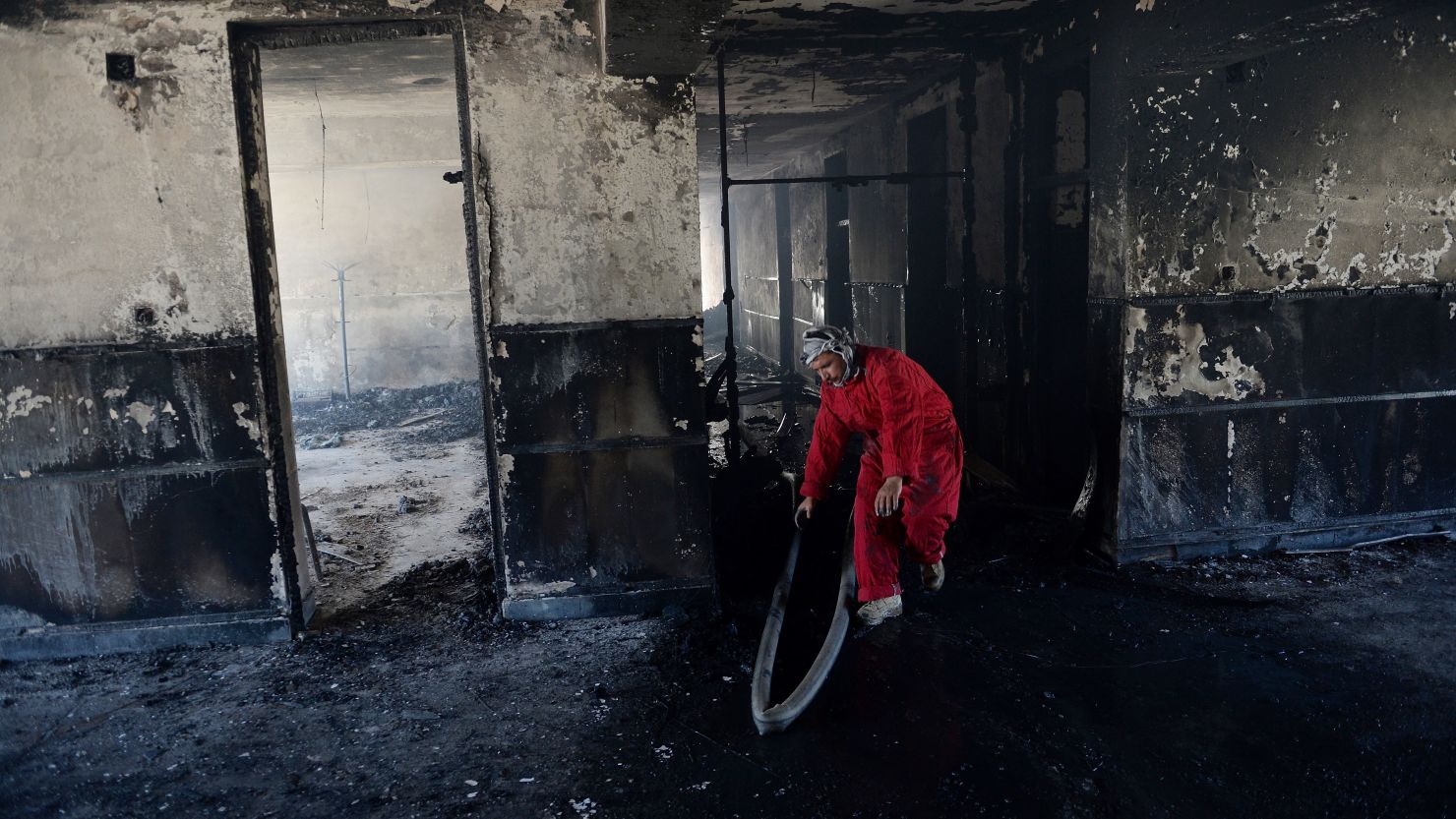 A firefighter inspects the interior of the provincial governor's office following a suicide attack in Bazarak, on May 29, 2013.