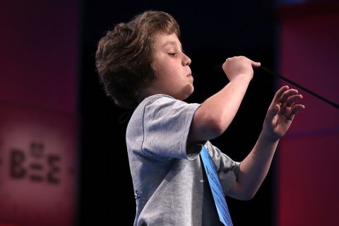 Alexander Schembra of Lillington, North Carolina, lowers the microphone before attempting, and failing, to spell "Beethovenian" during round three on May 29. Beethovenian is an adjective used to describe things that are related to or characteristic of Ludwig van Beethoven, his works or musical style.  