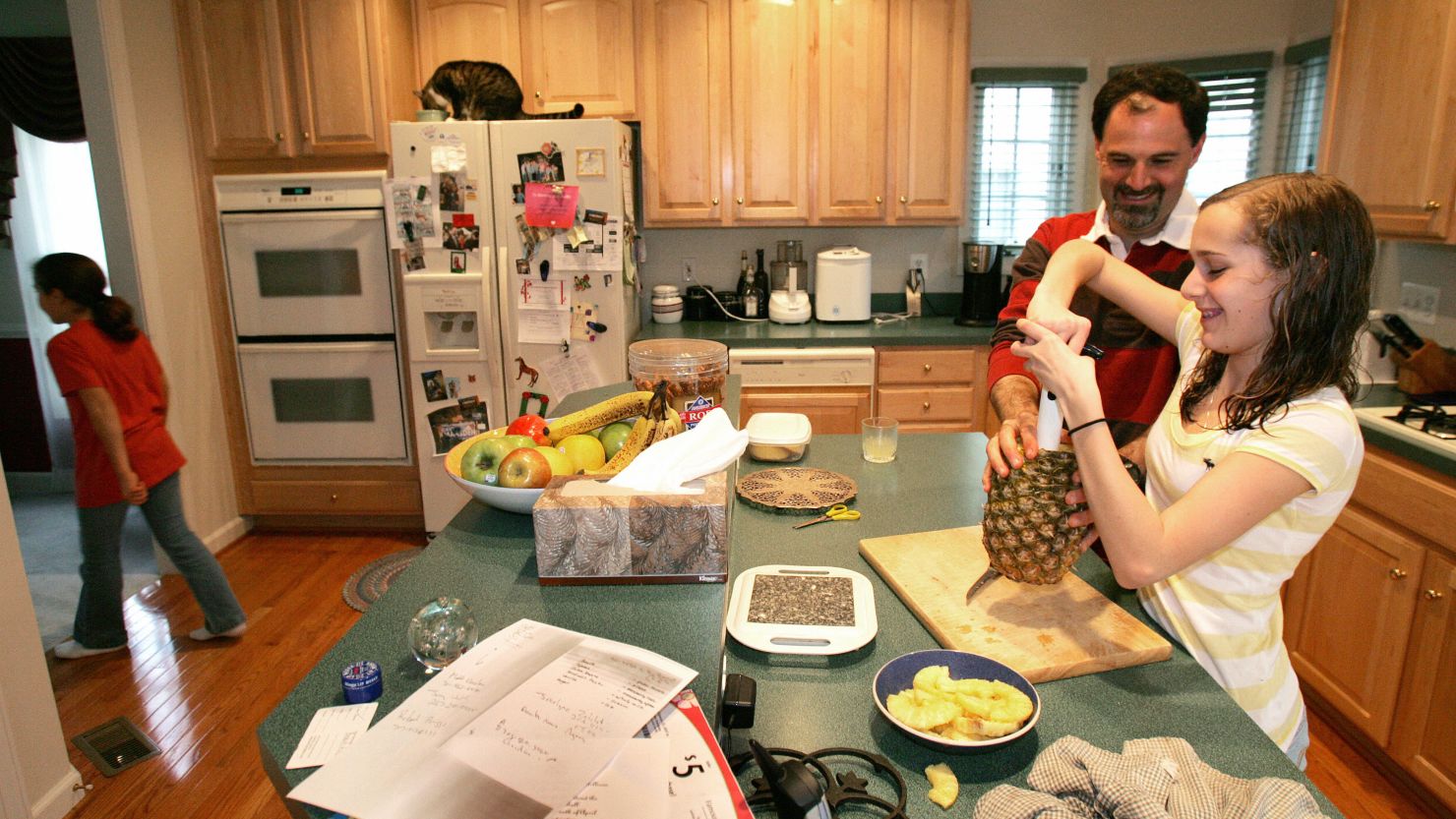 A stay-at-home dad helps his daughter. A  study finds that more mothers are the chief breadwinners in their families.

