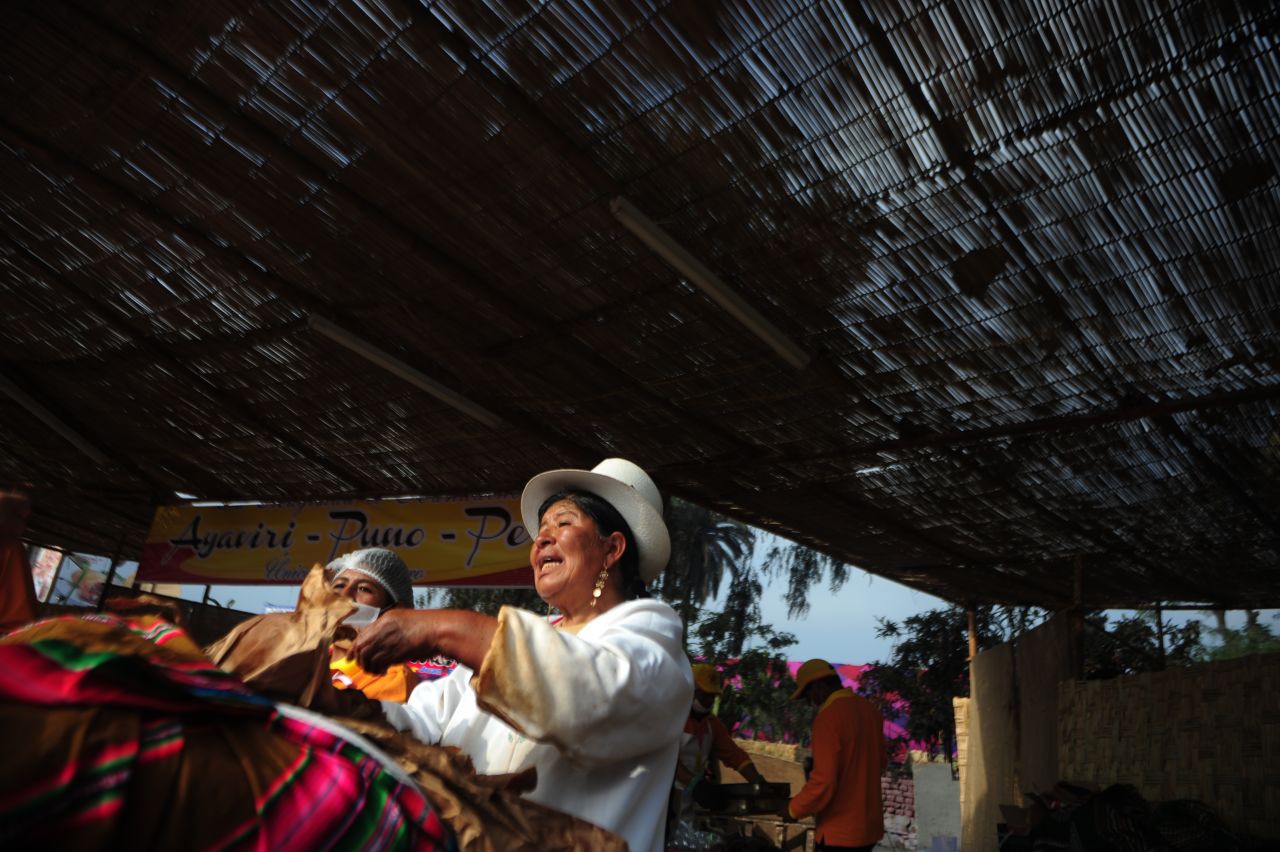 Women call out for customers during the Mistura food festival in Lima. The annual event promotes Peruvian cuisine from across the country.