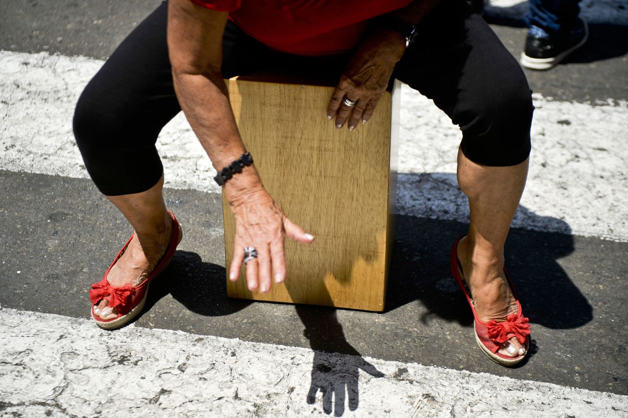 A woman plays a cajon, a box-shaped percussive instrument of Afro-Peruvian origin, during the International Peruvian Cajon Festival in Lima on April 13.