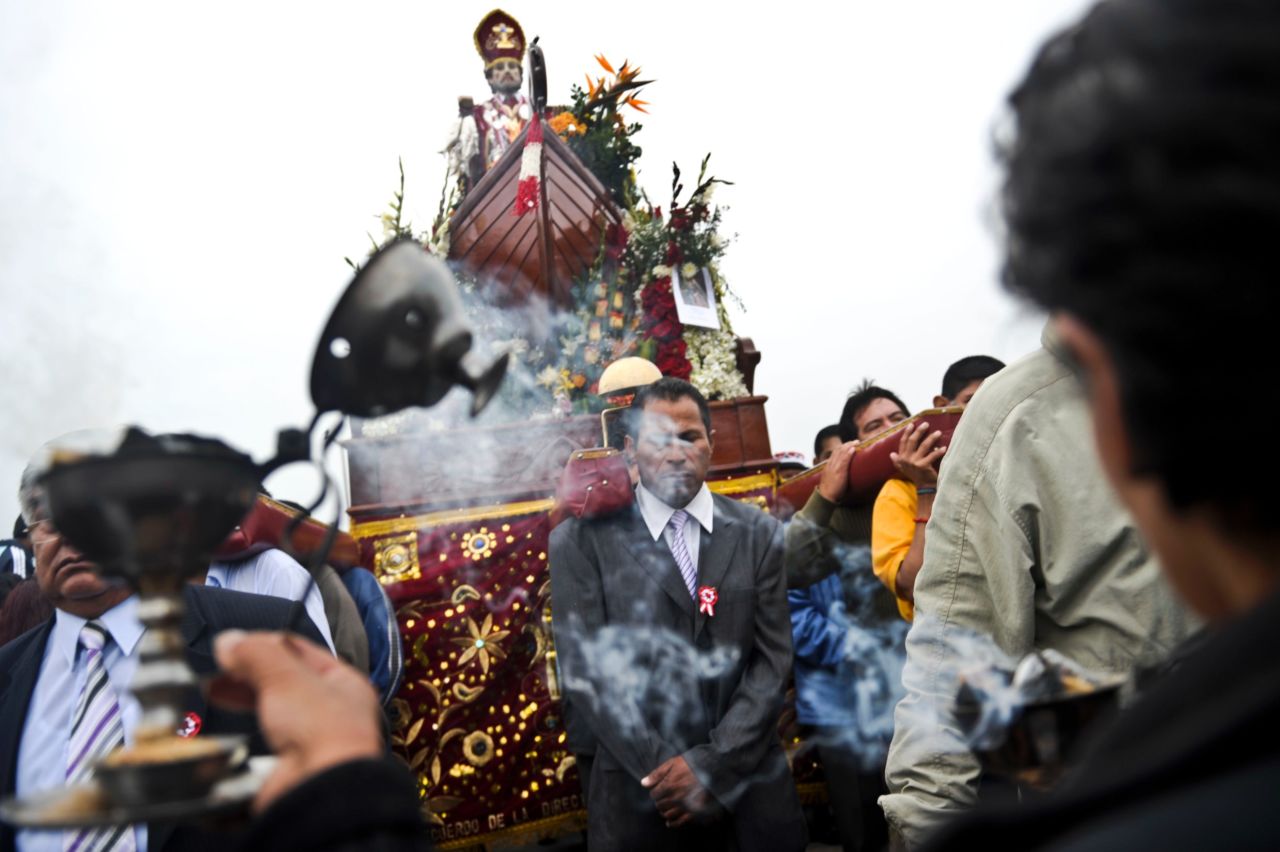 Catholics take part in a procession carrying an image of St. Peter, the fishermen's patron saint, at the port of Chorrillos.