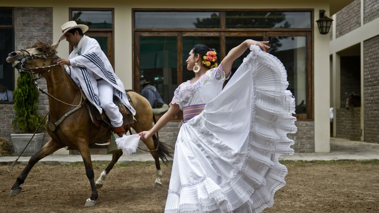 A man rides a Peruvian Paso horse next to a woman performing the traditional marinera dance in Lima on February 7.