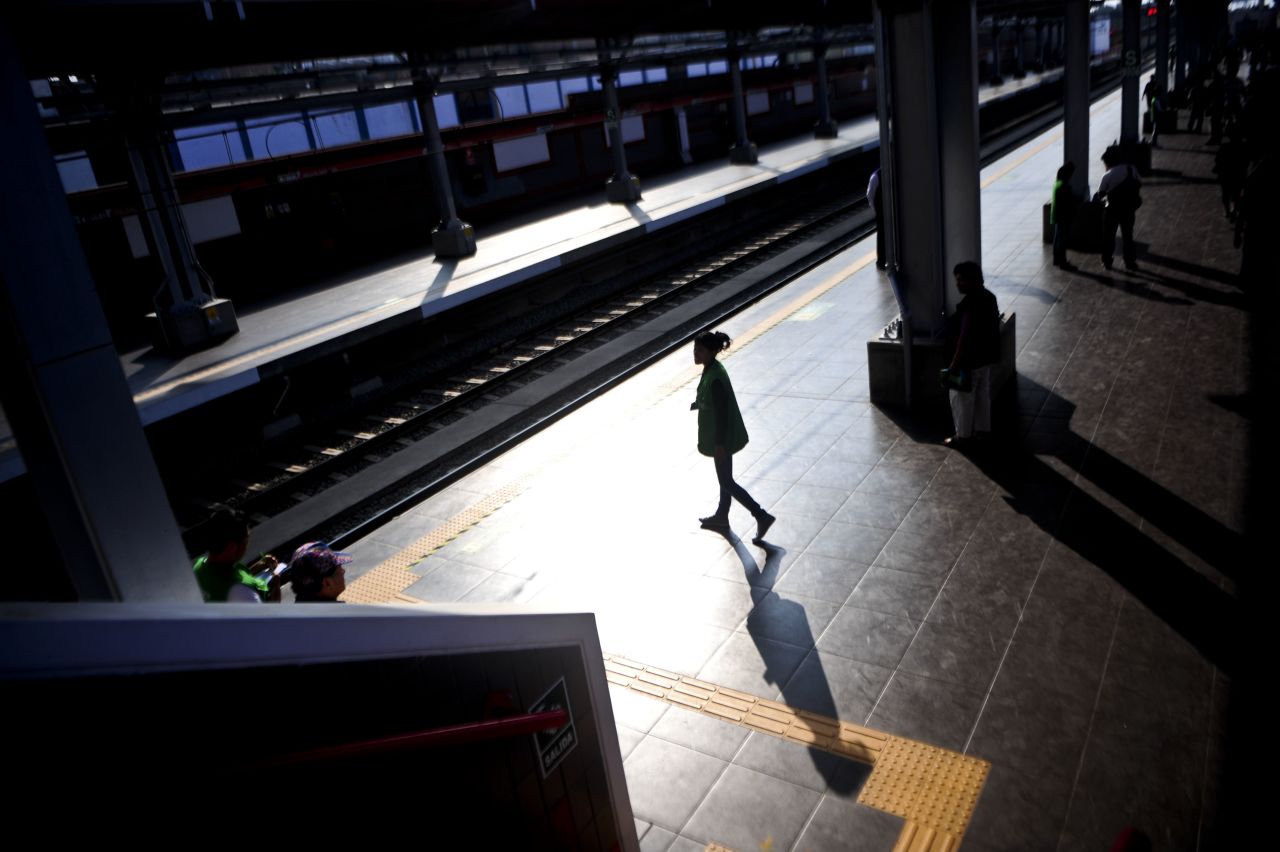 Commuters arrive at one of the stations of Lima's first electric train in January 2012.