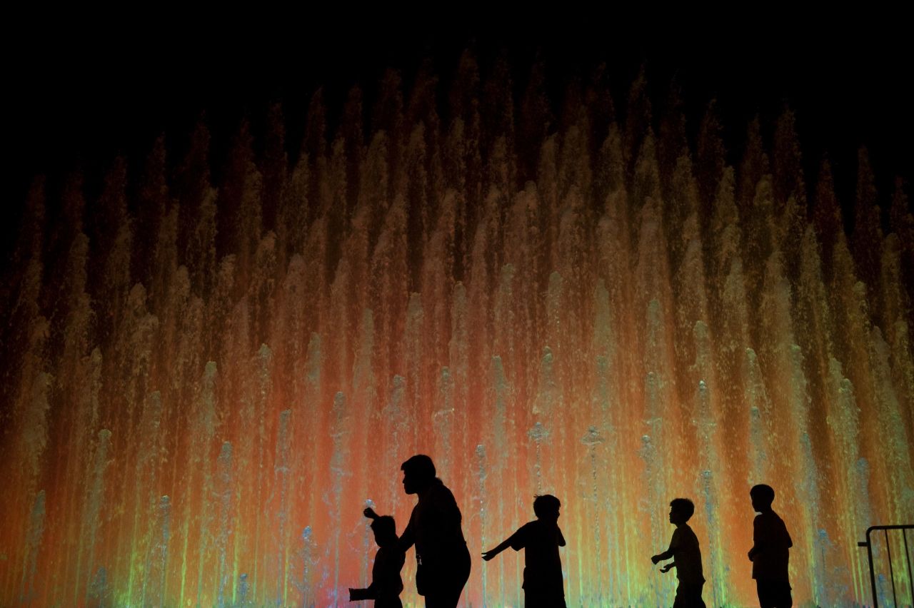 Children play in front of one of the fountains at the Parque de la Reserva in Lima.