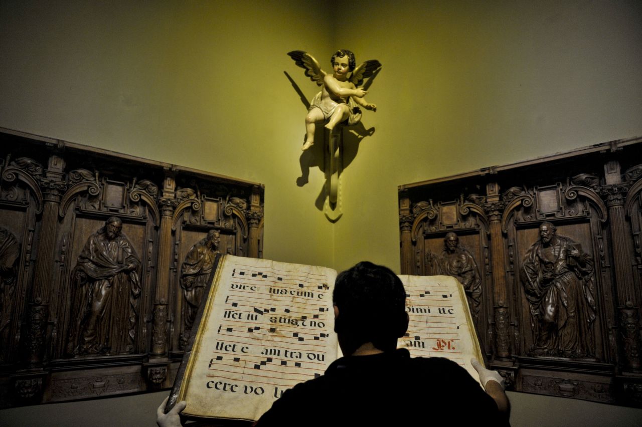 A man looks at a choral book during a tour of the ancient Cathedral of Lima.