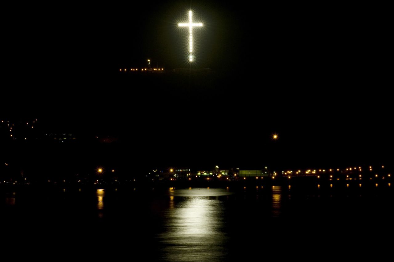 An illuminated cross, "La Cruz del Morro," lights up the sky in Lima on February 23, 2010. It was built using the remains of electricity towers destroyed by Shining Path guerillas in the 1980s. Its construction coincided with Pope John Paul II's visit to the country in 1988.