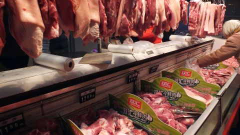 A Chinese customer selects pieces of pork, supplied by Shuanghui, which controls the country's largest meat-processing company in May 2013. China's Shuanghui International moved to buy US meats icon Smithfield Foods for $4.7 billion this week. 