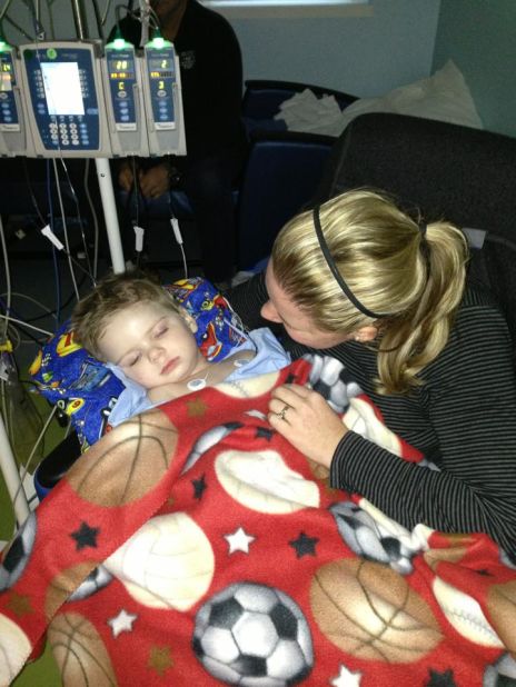 Halstead comforts Tripp at the hospital in February. She had just learned he contracted meningitis and had heart inflammation. Doctors informed Stacey and Bill that their son would need another surgery to replace a pump near his brain. 