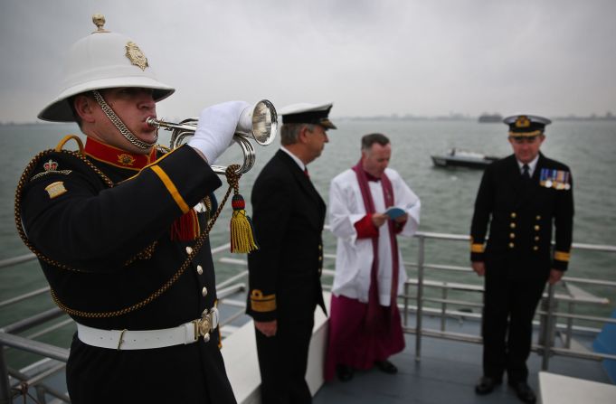 Royal Marine Bugler Dave Nevatte plays the Last Post during a wreath laying ceremony.