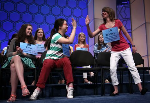Isabel Cholbi, right, of San Bernardina, California, celebrates after spelling "telergy," in round five on May 30. Telergy is the hypothetical action of one person's thoughts and desires on the brain of a different person via an unknown form of energy transmission.  