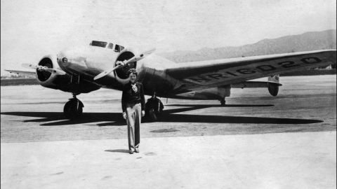 Earhart poses in front of her plane in the 1930s.