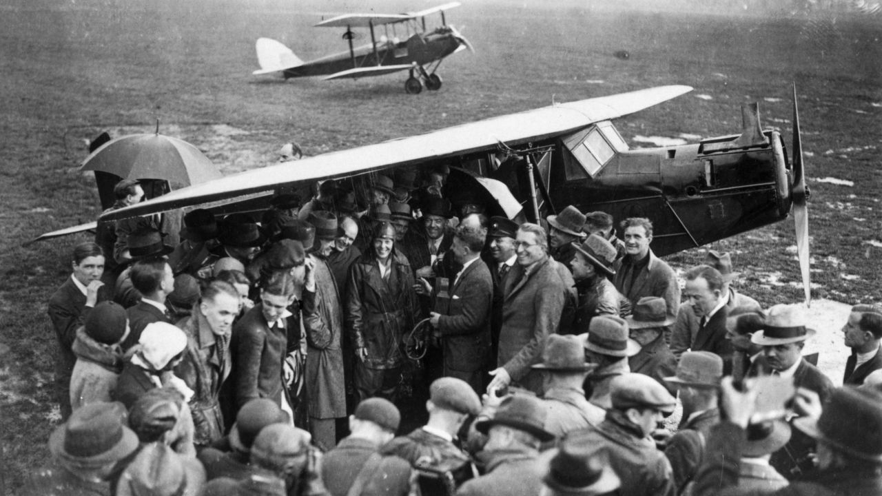 A crowd surrounds Earhart, center, upon arrival at Hanworth airfield in London after she crossed the Atlantic Ocean in 1932.