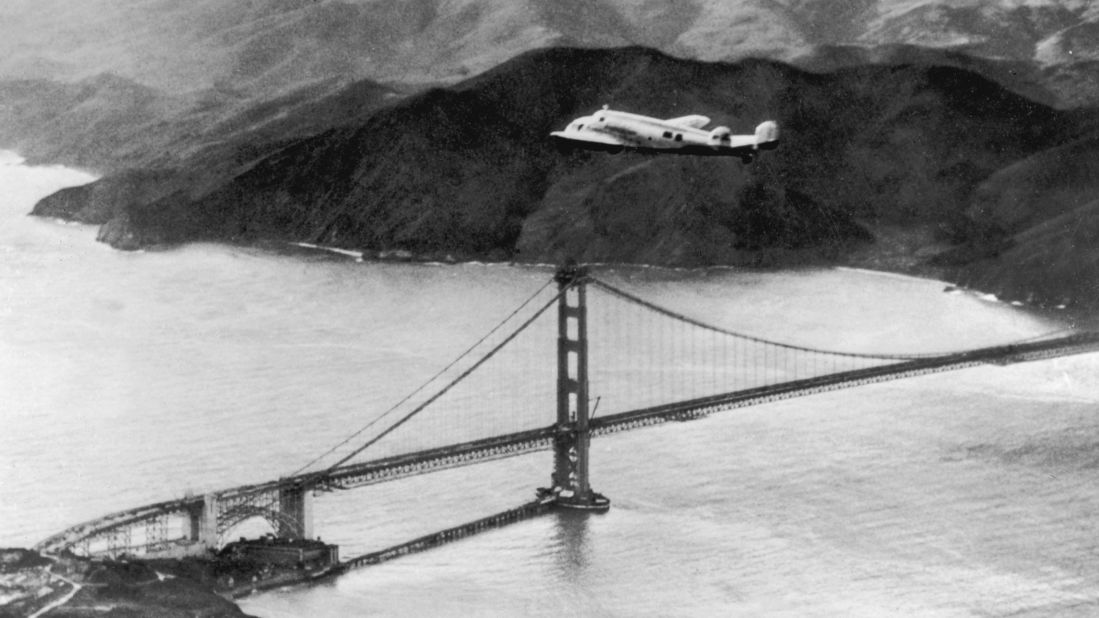 The Lockheed Electra 'Flying Laboratory' piloted by Earhart and Fred Noonan flies over the Golden Gate bridge in Oakland, California, at the start of a planned around-the-world flight on March 17, 1937. The trip had to be abandoned after the plane crashed on takeoff in Hawaii.