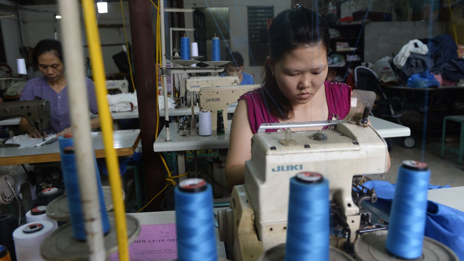 Women work at a small size garment workshop on the outskirds of Hanoi on May 2, 2013. 