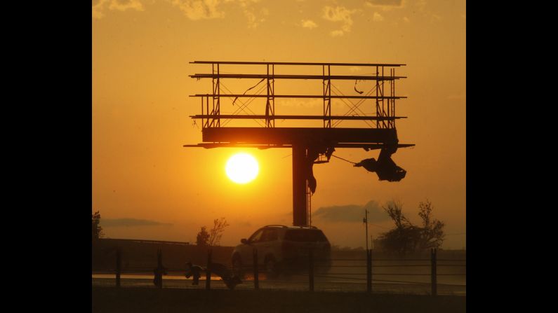 Tornado debris hangs from a billboard sign, which was destroyed along Interstate-40 near El Reno on May 31.