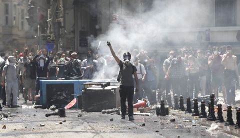 Turkish protesters wearing gas masks face off against riot police near Istanbul's Taksim Square on June 1. 