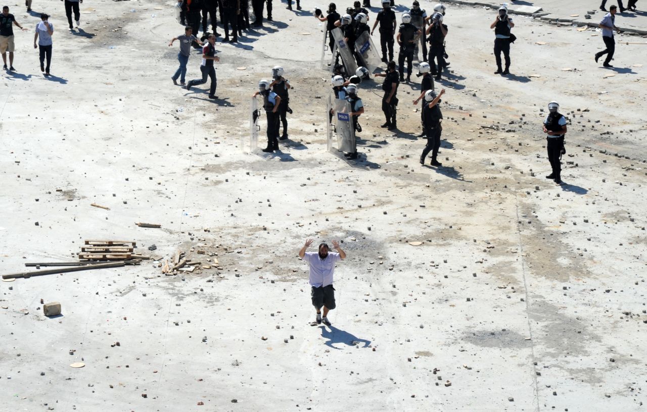 A man flees the clashes between Turkish protestors and riot police on June 1. On Friday, May 31, riot police stormed the growing camp in Gezi Park with water cannons and tear gas, pushing protesters into surrounding streets and triggering the clashes that have continued for more than 24 hours.