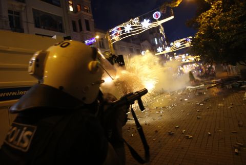 Riot police fire tear gas into the crowd of protesters overnight on Friday, May 31.