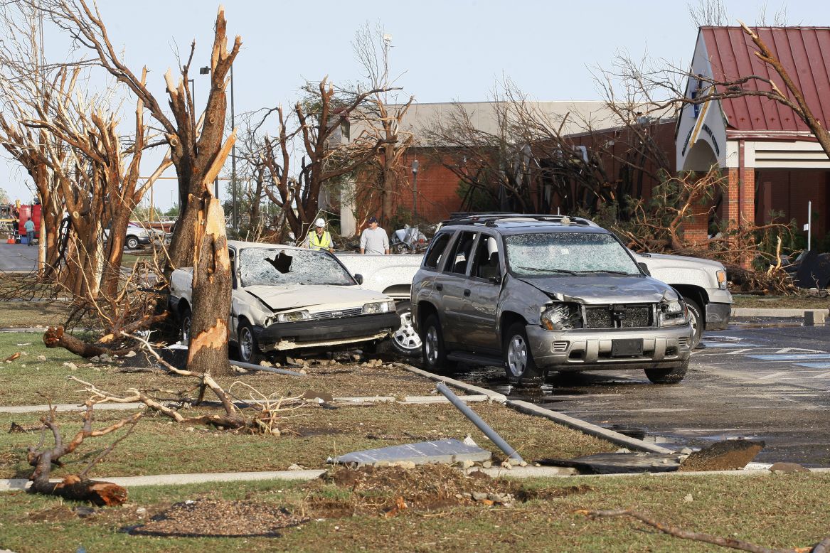 Destroyed trees and cars stand along a road at the Canadian Valley Technology Center in El Reno on June 1.