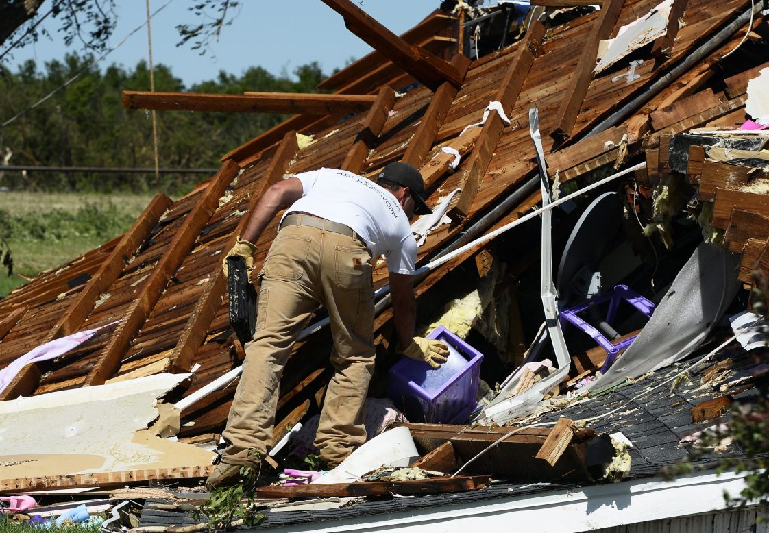 A man searches through the rubble of a home in El Reno on June 1. A large part of Moore, Oklahoma, was without power, as were parts of El Reno and Union City.
