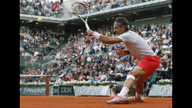 Spain's Rafael Nadal returns to Italy's Fabio Fognini on June 1. Nadal took the match 7-6(5), 6-4, 6-4.