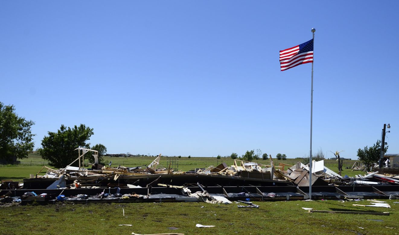 An American flag flies above the destroyed remains of a mobile home in El Reno on June 1.