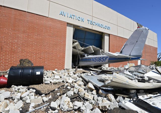 The tail section of a plane juts out of a crumbling building at a technology school in El Reno on June 1.