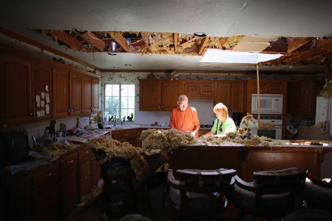 Bill Thesing, who was injured in his home when a tornado hit, returns from the hospital to to salvage items from his home with the help of his friend Tammy Hicks on Saturday, June 1, in El Reno, Oklahoma.