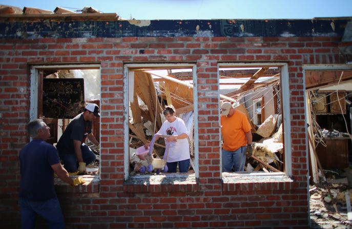 Dustin Horn, second from left, helps his parents, JoAnn and Fred Horn, salvage items from their home on June 2, two days after a tornado ripped through El Reno, Oklahoma.