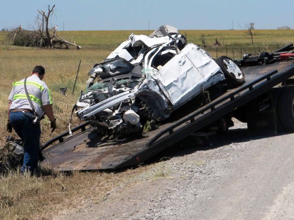 Crews haul away a mangled truck on Sunday, June 2, that storm chasers Tim Samaras, his son Paul Samaras and Carl Young were using to track the tornado that hit El Reno, Oklahoma. The three men, who had devoted their lives to hunting powerful storms died in the middle of the chase. Seventeen tornadoes were reported in the Oklahoma City and St. Louis areas on Friday, May 31.