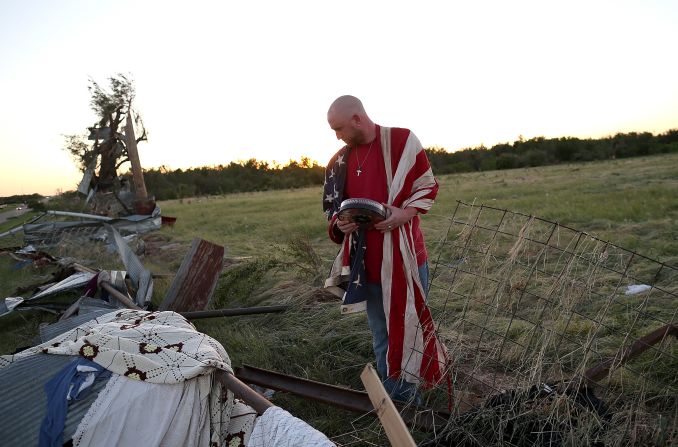 Mark Reynolds sifts through debris to salvage personal items in El Reno on Saturday, June 1.