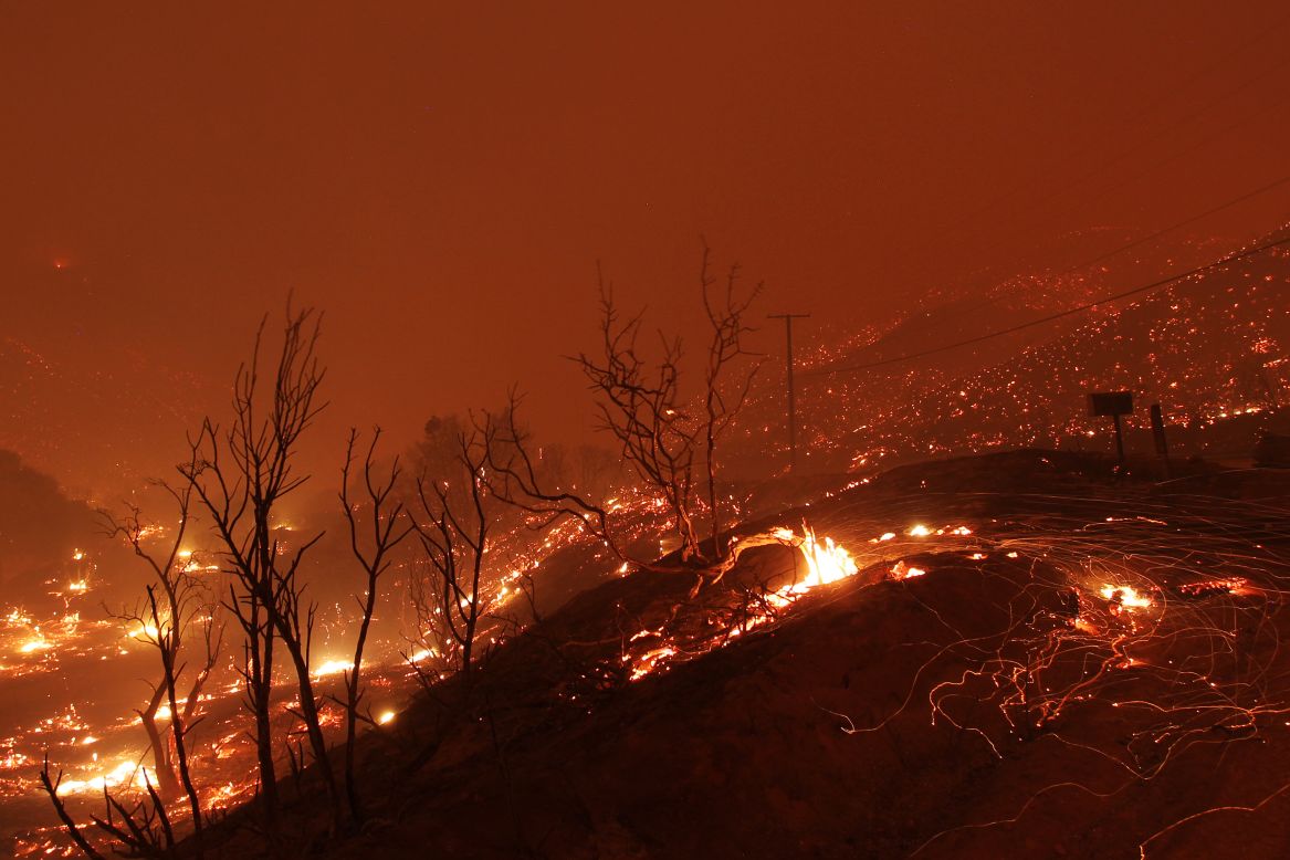 Hills glow with fire as the blaze sweeps through an area near Lake Hughes on June 1.