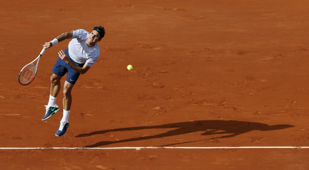 Switzerland's Roger Federer serves to Gilles Simon of France during a fourth-round match of the French Open on Sunday, June 2, in Paris. Federer defeated Simon 6-1, 4-6, 2-6, 6-2, 6-3.