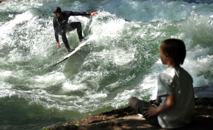 The German river is nestled in the heart of Munich's English Gardens, attracting surfers late into the night and a steady stream of onlookers. 