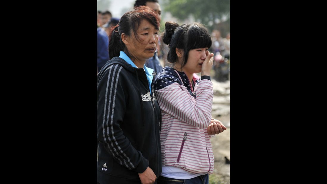 Two women wait for news about a family member. It took six hours to bring the fire under control.