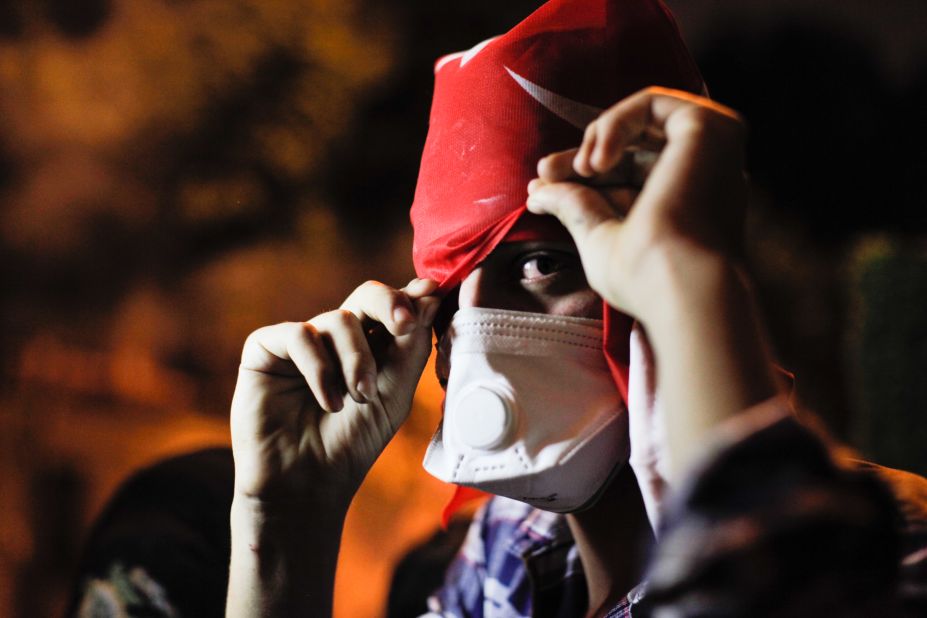 A protester covers his face on June 3 near Erdogan's office in Istanbul. 